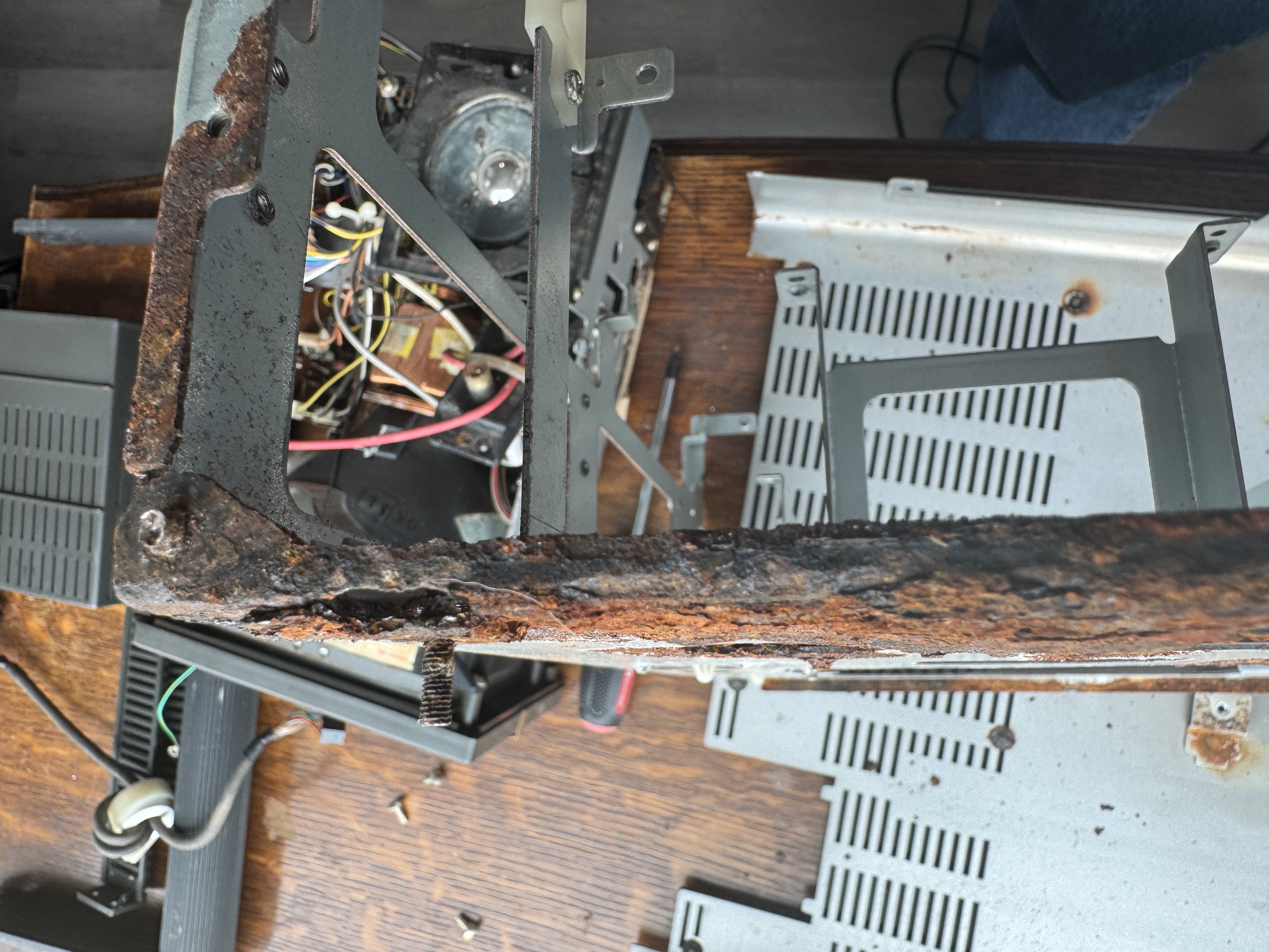 Close‑up of a drilled screw head to free the chassis